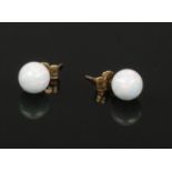 A pair of 9ct gold mounted opal stud earrings.