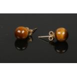 A pair of 9ct gold mounted tigers eye ear studs.