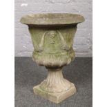 A cast concrete urn shaped garden planter.