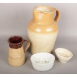 A collection of c19th stoneware to include large salt glazed pitcher, jelly moulds etc.