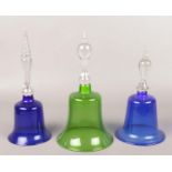 Three Victorian coloured glass bells with baluster clear handles. Largest 29cm. No cracks or