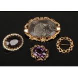 Four yellow metal brooches including Victorian. Fossilized marble panel brooch with scroll mantling,