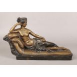 A bronzed metal figure of a reclining nude in Classical style. Indistinctly signed, 33cm.