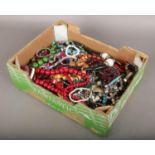 A box of costume jewellery beads, bracelets etc.