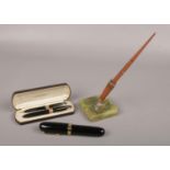 An oversize fountain pen, Wahl Eversharp onyx based desk pen and a cased Sheaffer's pen set.