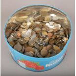 A tin of pre decimal and world coins.