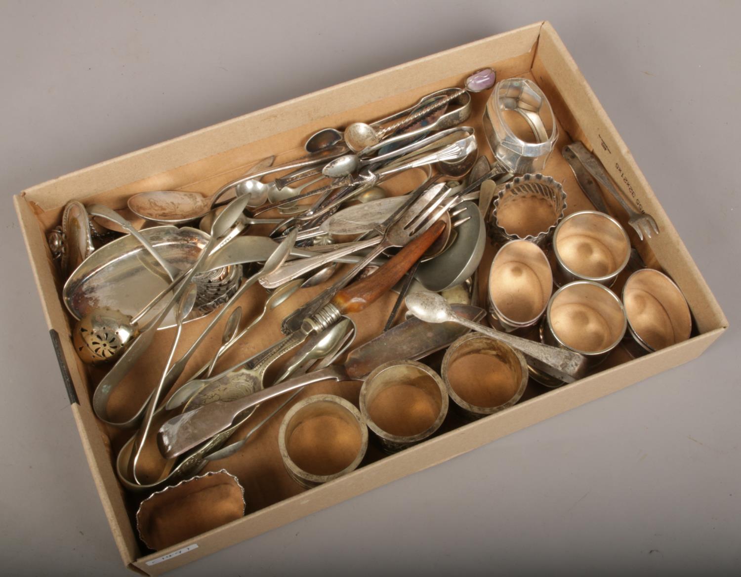 A tray of assorted silver plate flatware and napkin rings etc.
