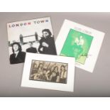 Three pieces of autographed ephemera, to include LPs signed by Julian Lennon, and Denny Laine from