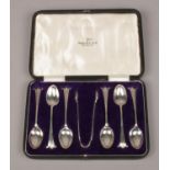A set of six George V silver teaspoons and pair of sugar tongues by Walker & Hall in original