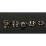 Five paste set rings, 9ct gold and silver. Including an Art Deco panel ring with sapphire coloured