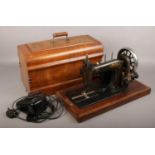 A mahogany cased electric sewing machine.