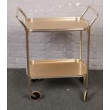 A two tier wheeled serving trolley