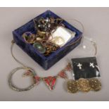A box of costume jewellery to include bangles, earrings, necklaces etc.