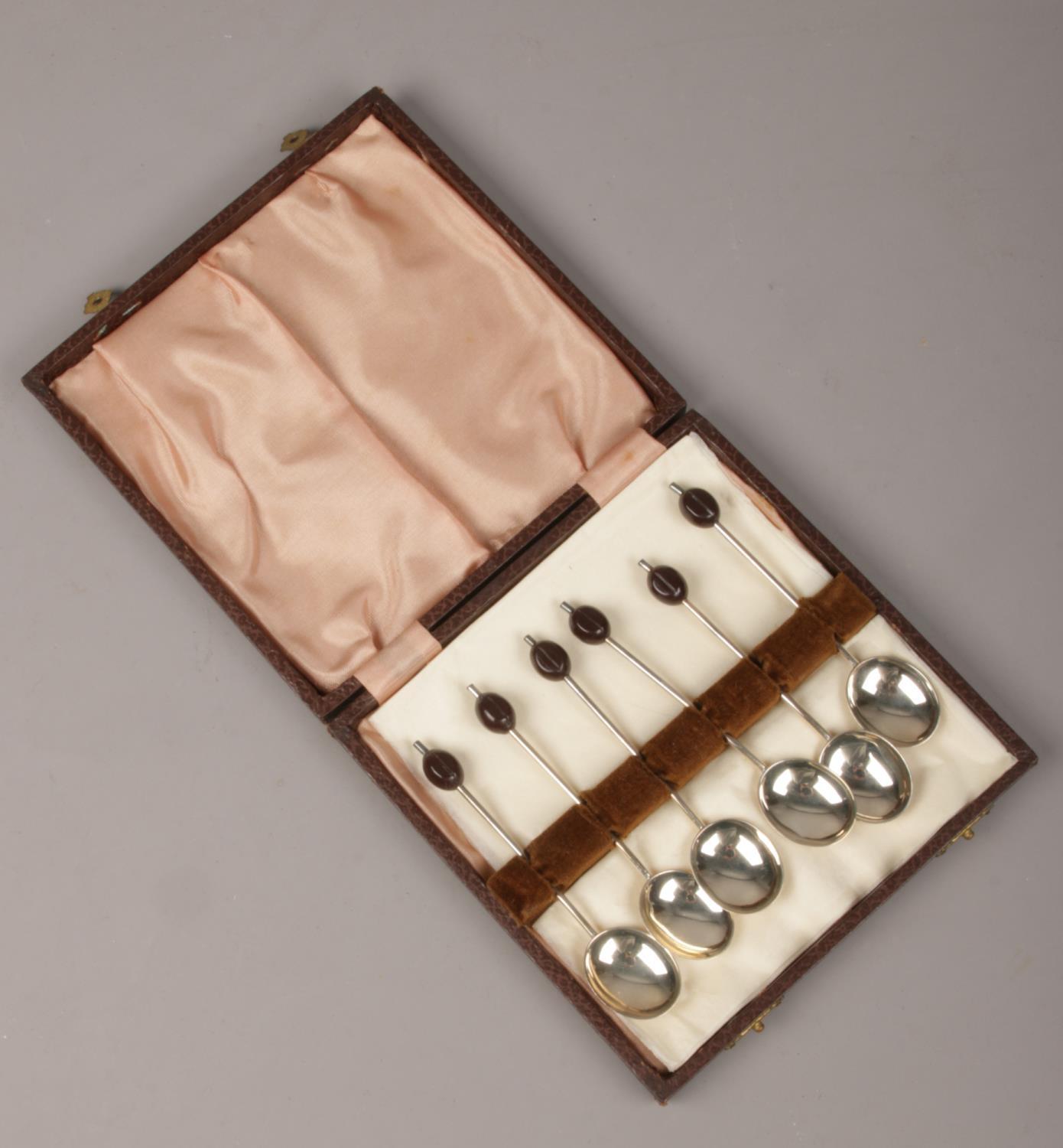 A cased set of six silver demitasse spoons with coffee bean terminals. Assayed Birmingham 1933.