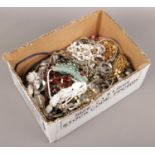 A box of costume jewellery to include necklaces, beads, bangles, etc.