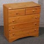 A pine chest of drawers ( approx 76 cm height 31 cm width)