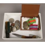 A box of collectables to include coins, medals, pocket knifes etc.