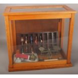 A Griffin & George Ltd display case to include a set of vintage 20th century post office scales