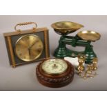A carved mahogany circular wall barometer, along with a set of Librasco kitchen scales and brass