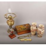 A mixed group lot to include oriental satsuma vases, brass oil lamp, native american scene box
