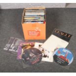 A box of pop LP records and 12inch singles.