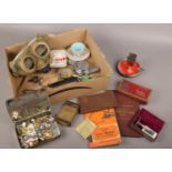 A box of collectables, to include gas mask, military buttons, chrome ash tray / matchbox holder etc.