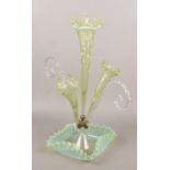 A Victorian Vaseline glass three flute epergne, raised on a crimped square base, 56cm high.