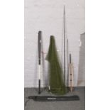 A collection of fishing equipment to include silstar fishing rod, pole, landing net etc.