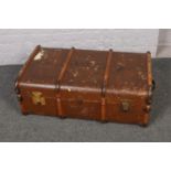 A wood and metal bound travel trunk, stencilled J.A.T.