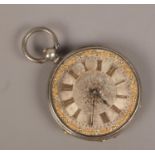 A silver fob watch with silver and gilt dial.