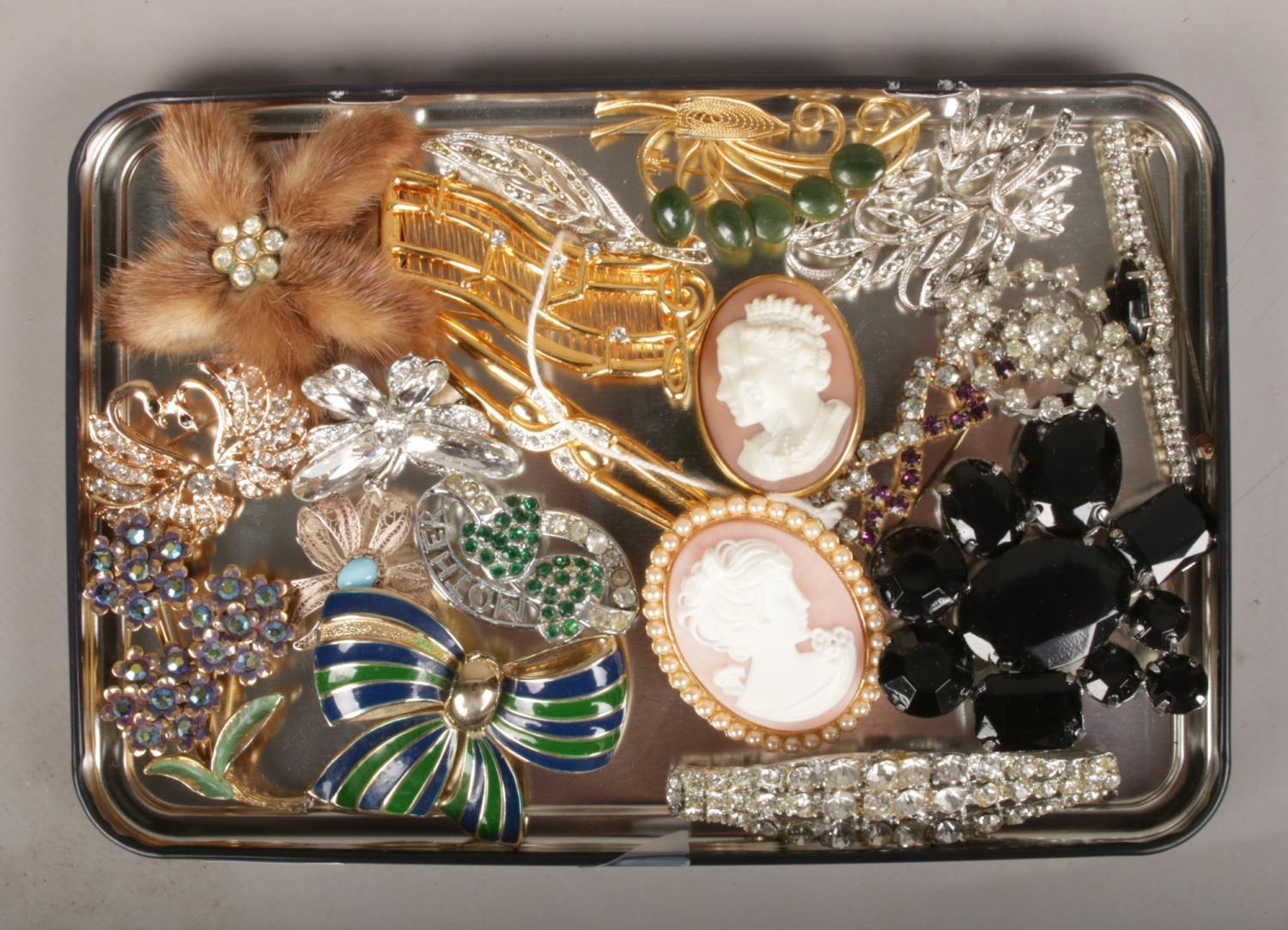 A tray of costume jewellery brooches, to include cameo, white paste etc.