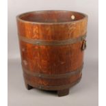 A mid 20th century coopered oak log barrel by makers R. Lister and Co. Dursley. 43cm.
