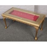 A gilt wood glass top display table. 100cm x 45cm x 50cm.