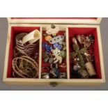 A vintage musical jewellery box containing clip on earrings, dress rings and other costume