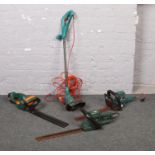 A Bosch electric strimmer, along with three electric hedge trimmers.