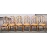 A set of six Continental carved oak canework dining chairs, raised on cabriole legs. (Damage to