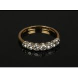 An 18ct gold seven stone diamond ring. Set with graduated brilliant cut stones. Approximately 0.