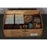 A box of tins and storage boxes to include wood inlaid examples.