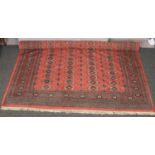 A red gound wool rug, 131cm x 170cm. Good condition.