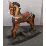 A wooden carved and painted rocking horse.