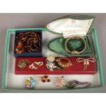 A tray of vintage costume jewellery including coloured paste brooches, boxed Legion bracelet watch