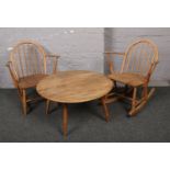 A child's vintage light elm Ercol rocking arm chair, matching arm chair, and a similar circular