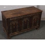 A large carved and panelled oak coffer. 115cm wide x 48cm depth x 71cm tall.