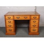 A George V oak leather top twin pedestal desk. Rich medium colour and with brass handles, 122cm x