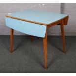 A retro drop leaf dining table with Formica top.