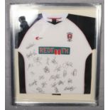 A framed signed Rotherham United football shirt.