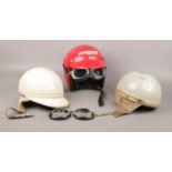 A collection of helmets, Nolan motorbike helmet with goggles, Lycett, Geno Paris examples