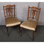 A pair of Edwardian carved and inlaid rosewood salon chairs.