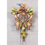 Hubert Herr carved wood black forest cuckoo clock with a carved bird pediment, two pine cone