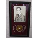 A framed picture of Elvis Presley containing a piece of his hair, COA to the back. Titled The